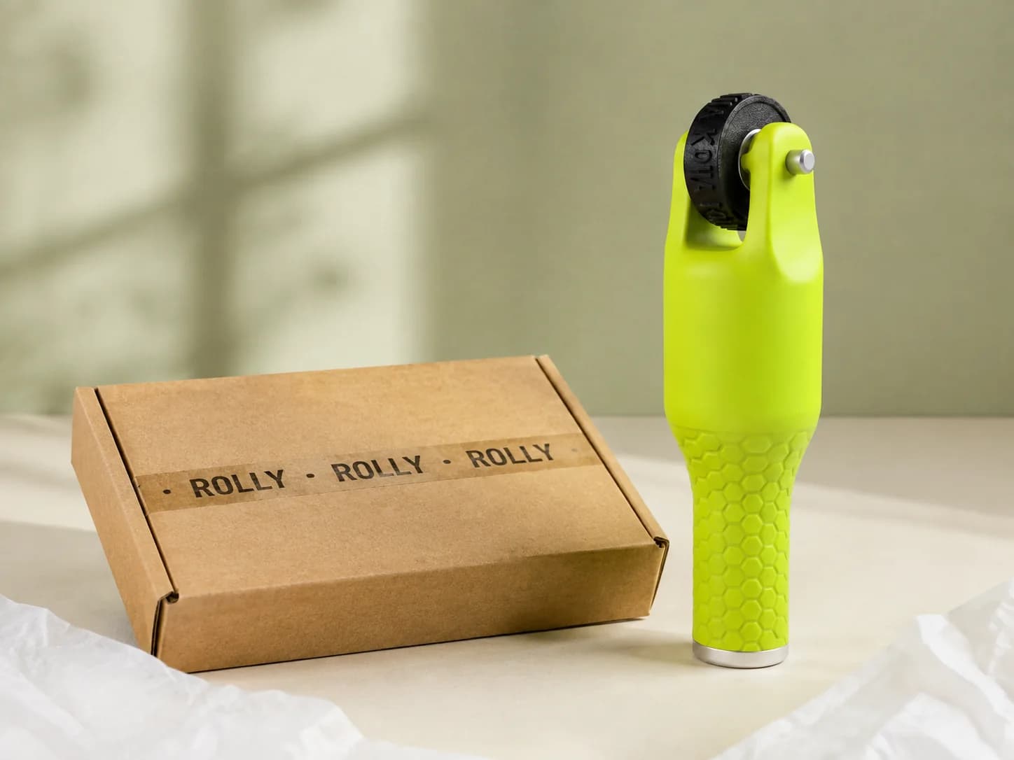 Packaging concept with a green Rolly roller stamp beside a kraft parcel and a repeating black imprint